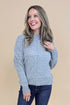 Front view of woman wearing Grey Center Seam Detail Sweater and blue jeans. 