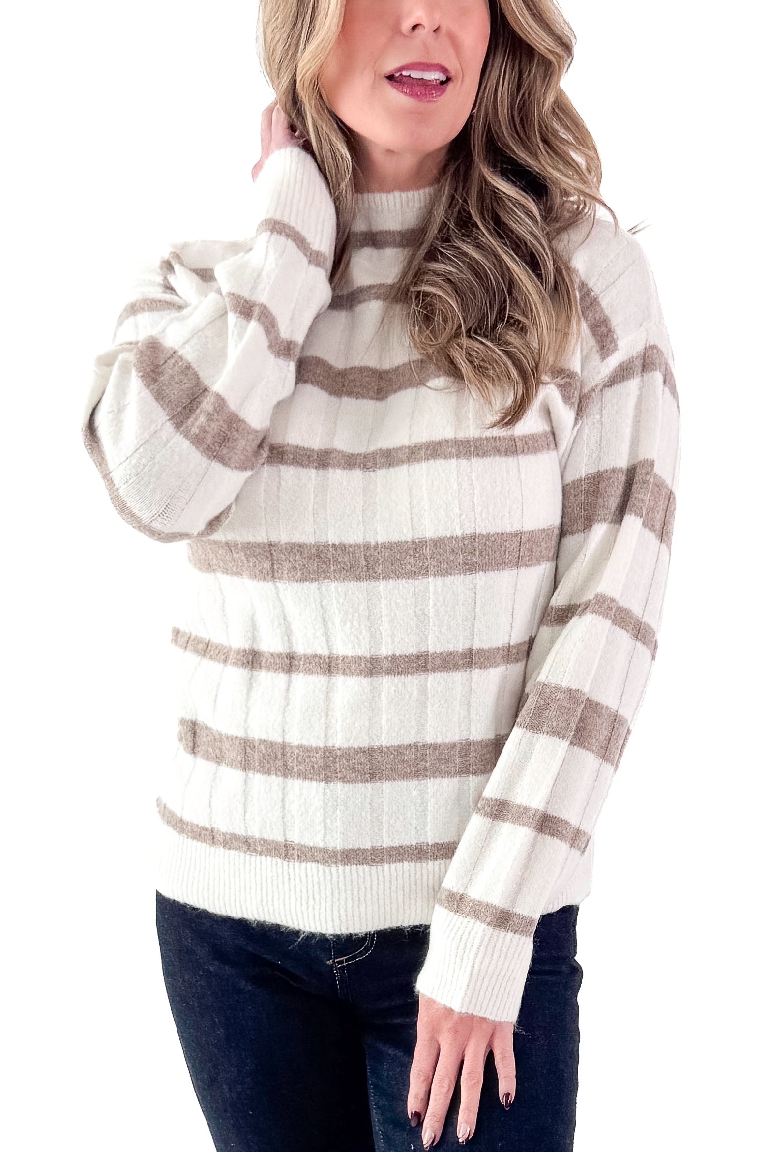 Front detailed view of woman wearing Taupe and Cream Striped Mock Neck Sweater with jeans against white studio background.