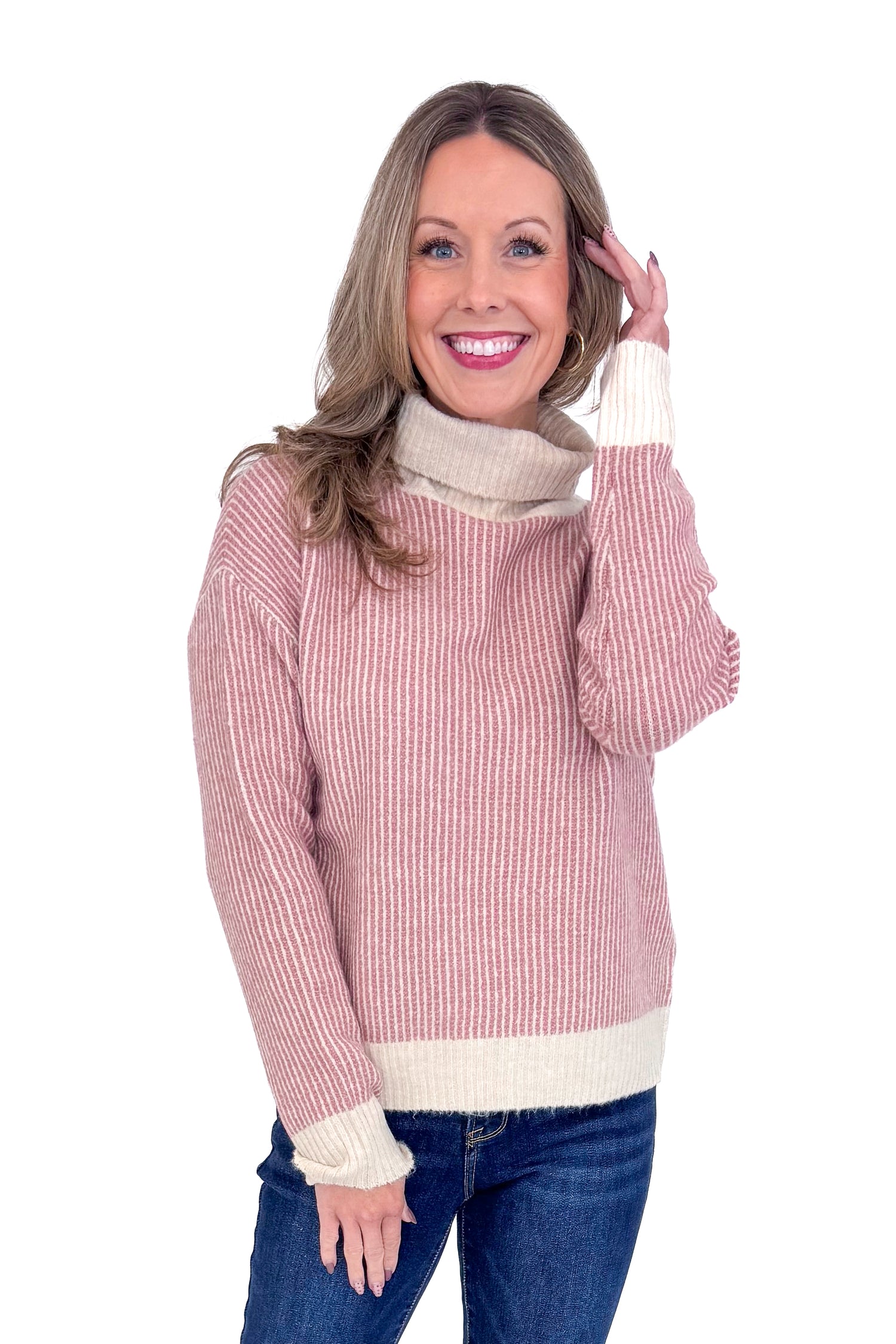 Front picture of woman wearing Mauve Striped Turtleneck Sweater and blue jeans against a white background.