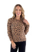 Front view of woman wearing Camel Leopard Crewneck Sweater with jeans against white studio background.