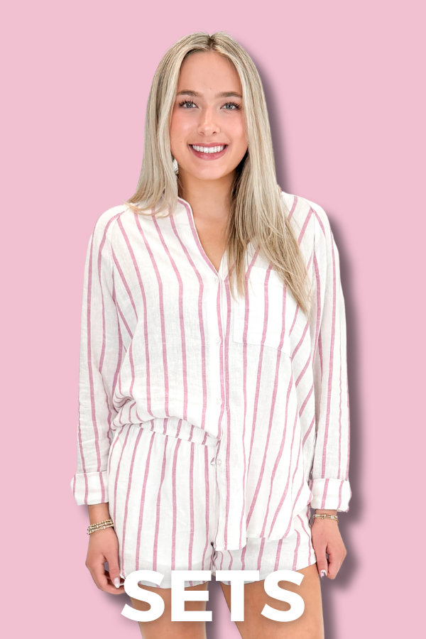 Woman wearing a white and pink striped dress on a pink background with 'SETS' text.