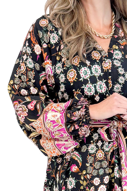 Detailed view of woman wearing Black &amp; Multi Printed Midi Dress with white studio background.