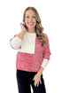 Front view of woman wearing Cream & Red Color Block Sweater with jeans against white studio background.