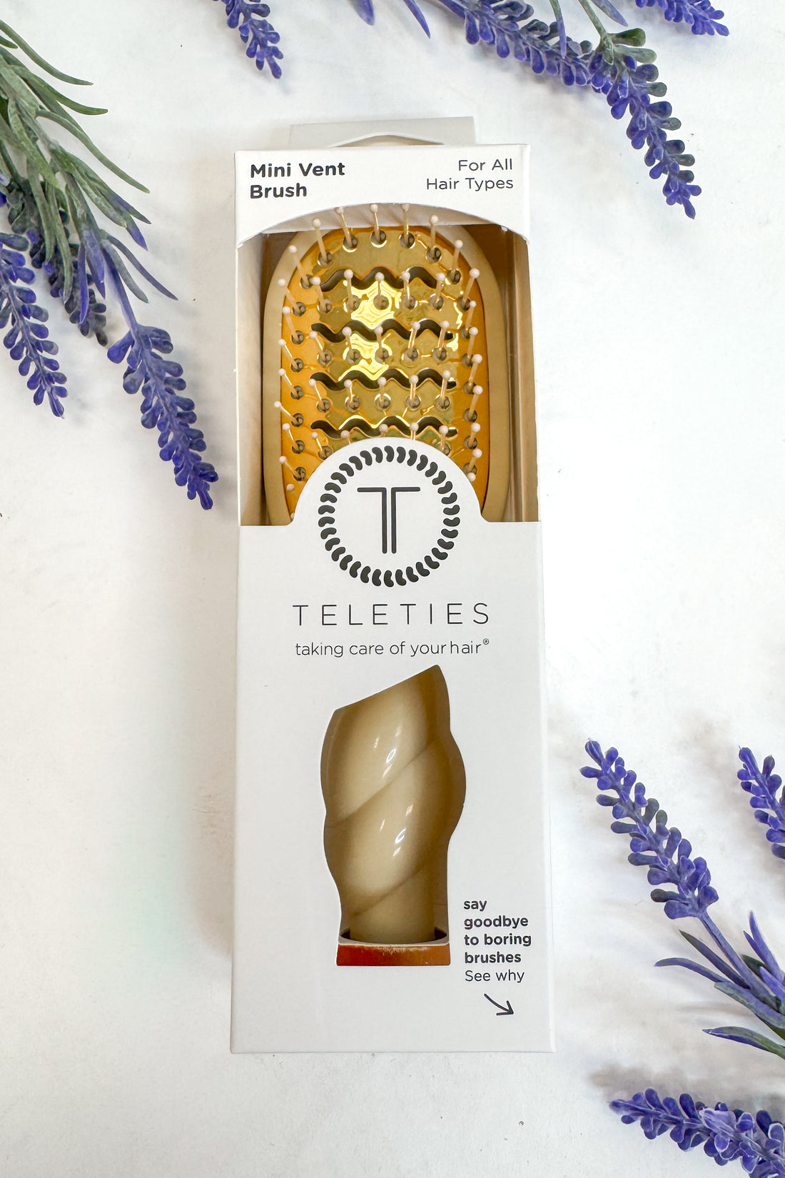 Teleties mini vent brush packaging with lavender flowers on a white background