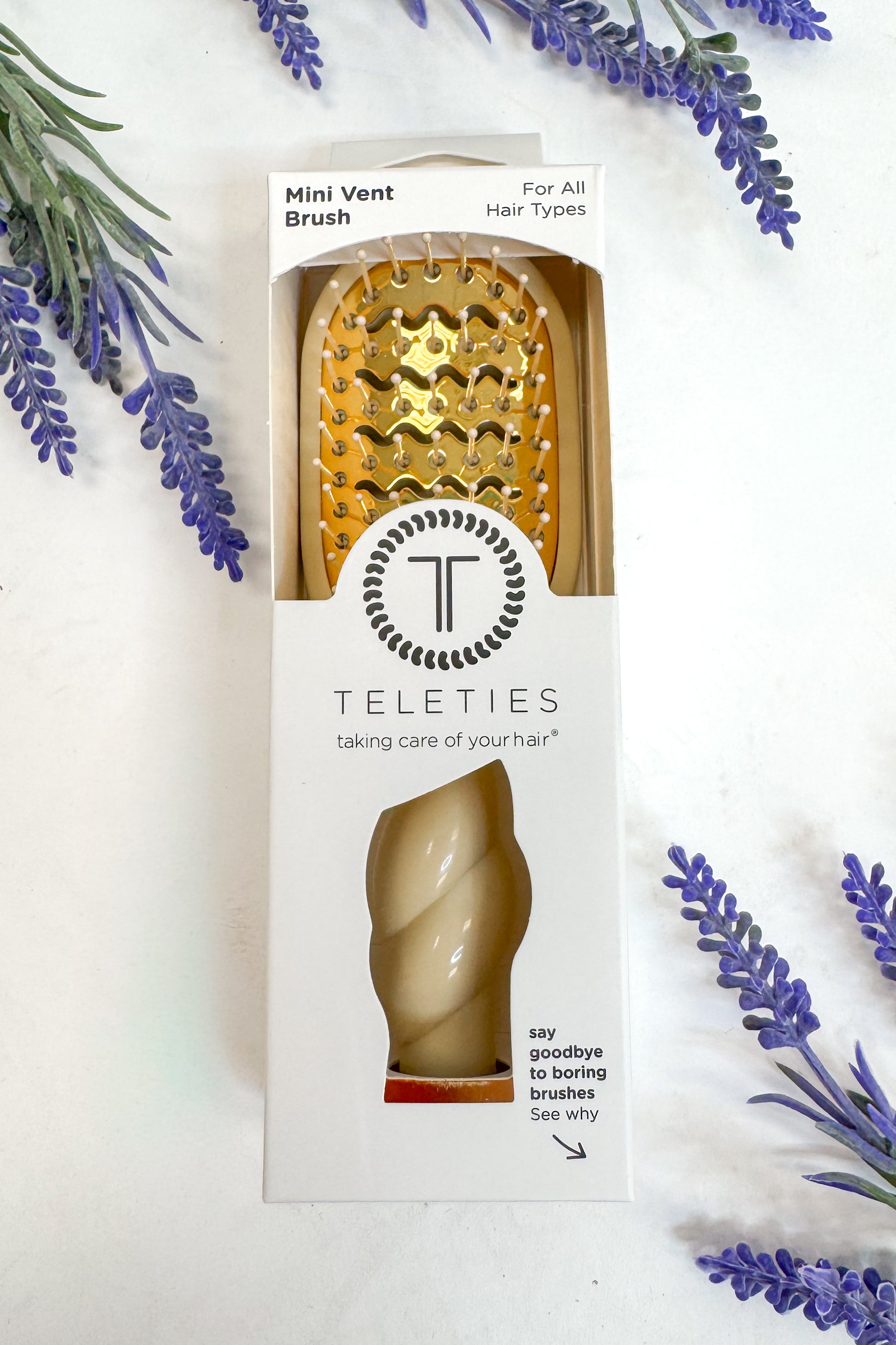 Teleties mini vent brush packaging with lavender flowers on a white background