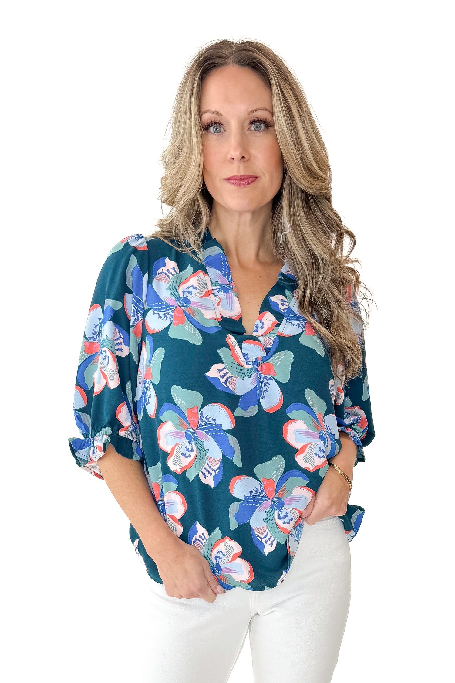 Front view of woman wearing Green &amp; Pink Floral Julie Top with jeans against white studio background.