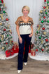Woman posing in front of Christmas trees with decorated gifts