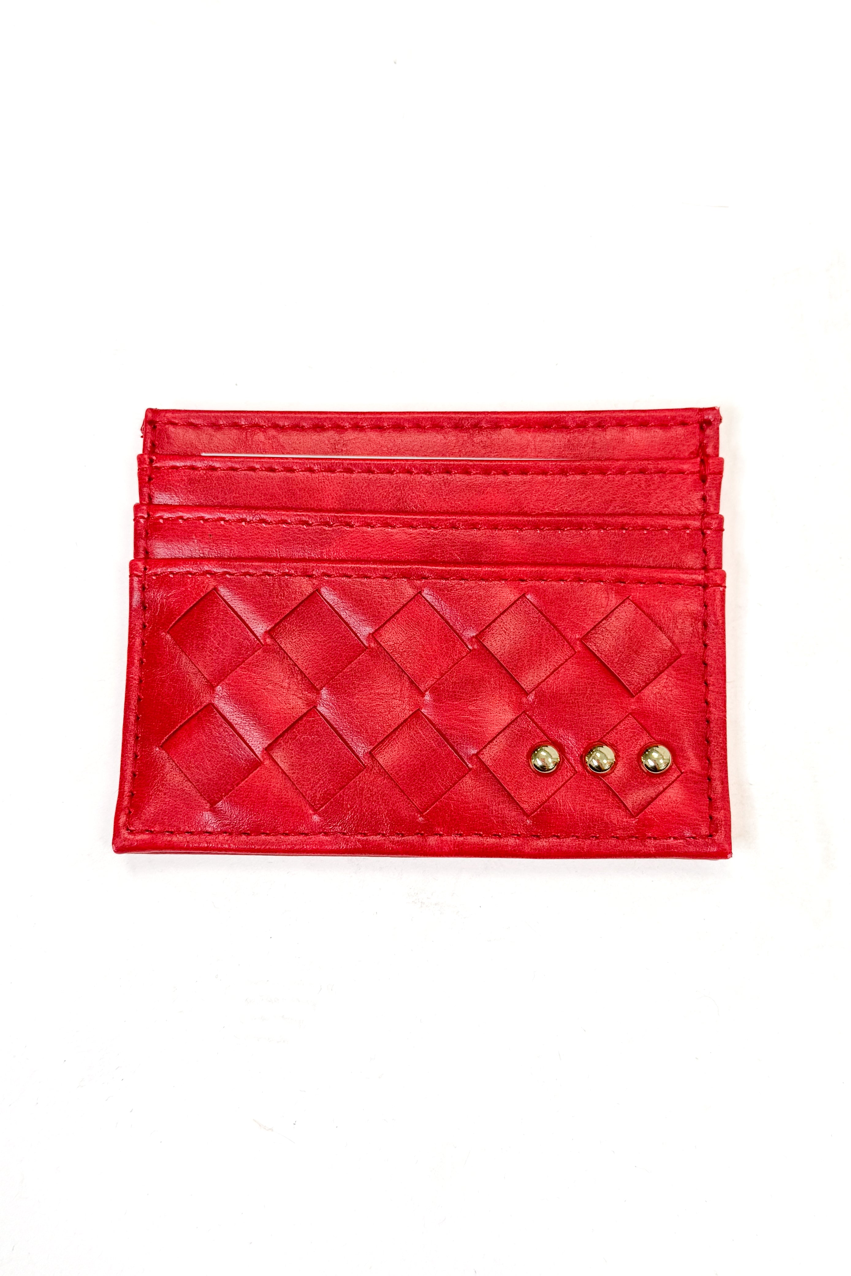 A red woven leather card holder wallet with two small gold heart-shaped studs on the front, displayed flat against a white background.