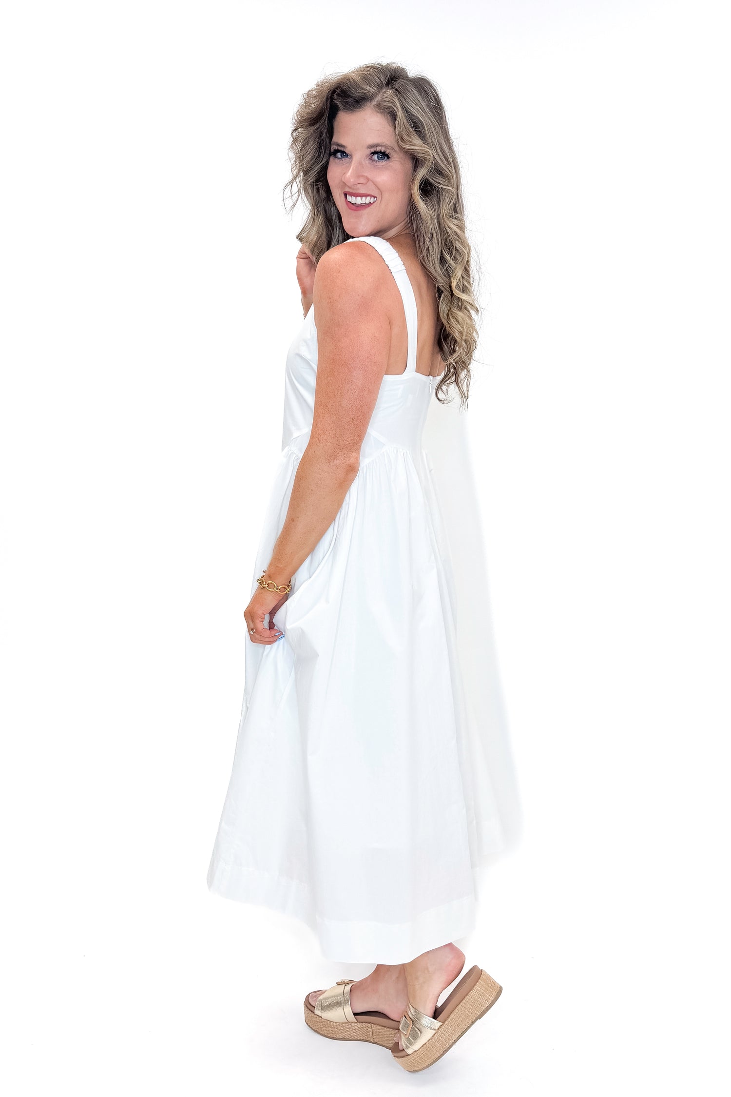 Side view of woman wearing Off White A-Line Midi Dress by PINCH against white studio background.