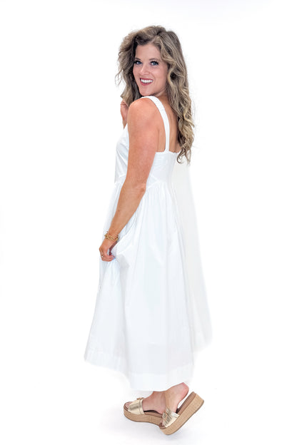 Side view of woman wearing Off White A-Line Midi Dress by PINCH against white studio background.