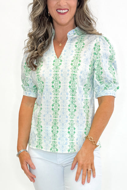 Front detail view of woman wearing Blue &amp; Green Vine Print Colette Top by Mary Square with jeans against white studio background.