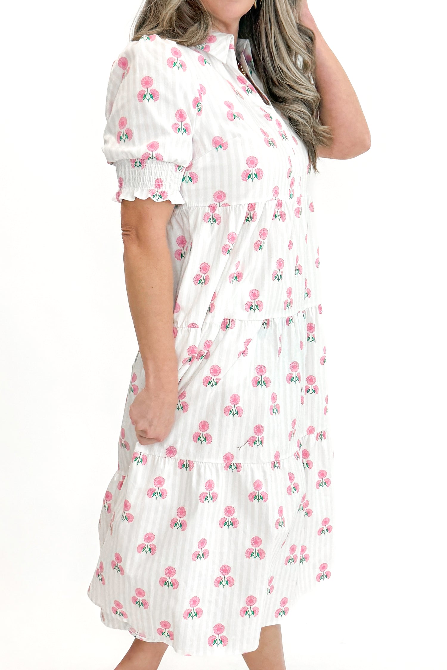 Side view of woman wearing Neutral Stripe &amp; Pink Floral Molly Dress by Mary Square with sandals against white studio background.
