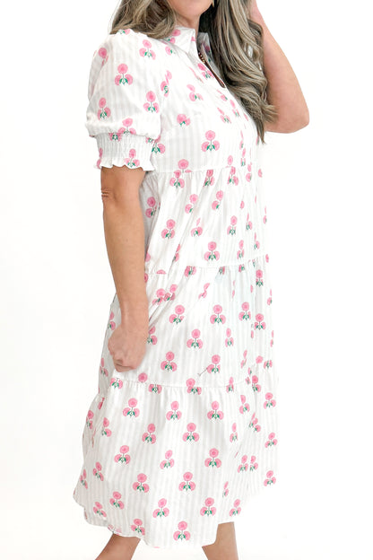 Side view of woman wearing Neutral Stripe &amp; Pink Floral Molly Dress by Mary Square with sandals against white studio background.