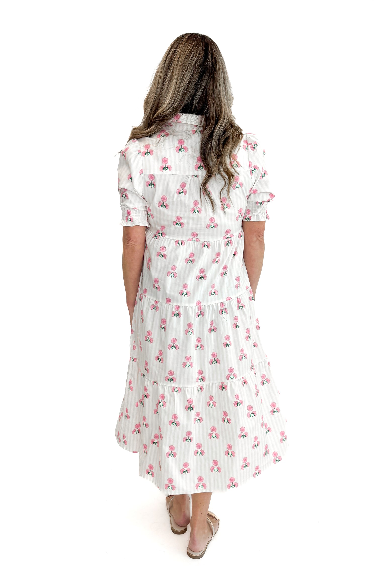 Back view of woman wearing Neutral Stripe &amp; Pink Floral Molly Dress by Mary Square with sandals against white studio background.