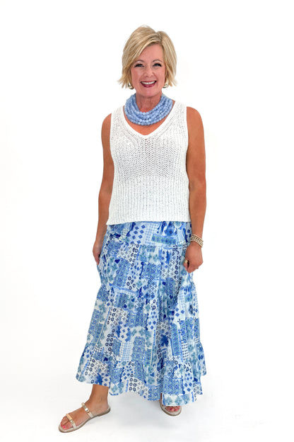 Front view of woman wearing top with Blue Patchwork Print Tiered Skirt by PINCH against white studio background.