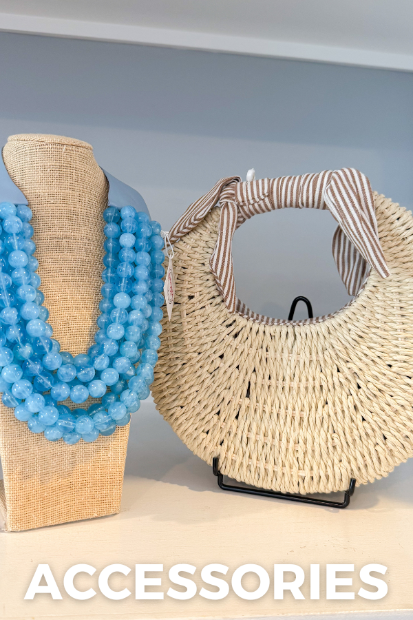 Woven handbag and blue beaded necklace on a mannequin against a gray background with 'ACCESSORIES' text.