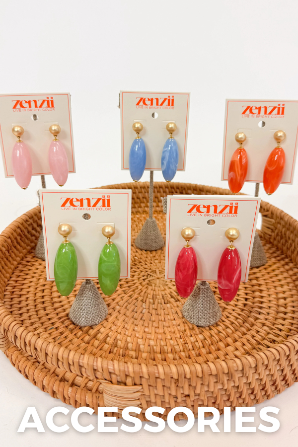 Set of colorful earrings on display with 'ZENZII' branding on a woven tray.