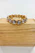 Gold bracelet with crystal stones on a wooden block
