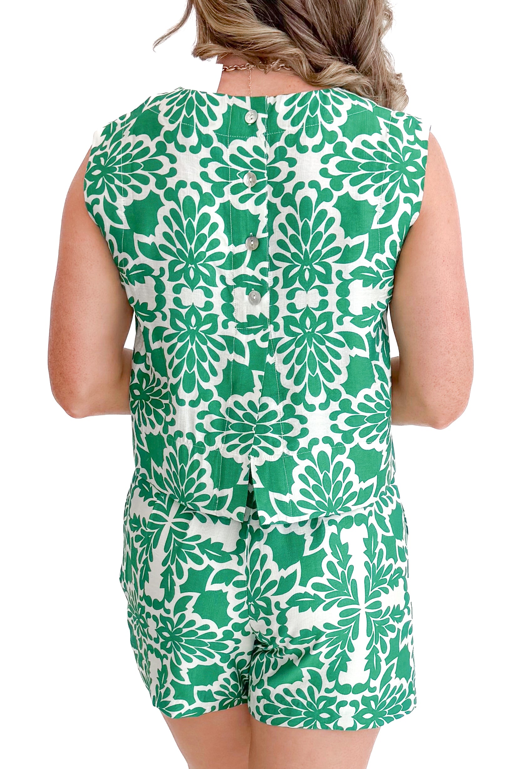 Back view of woman wearing Green &amp; Ivory Printed Shorts by Skies Are Blue with matching tank against a white background.