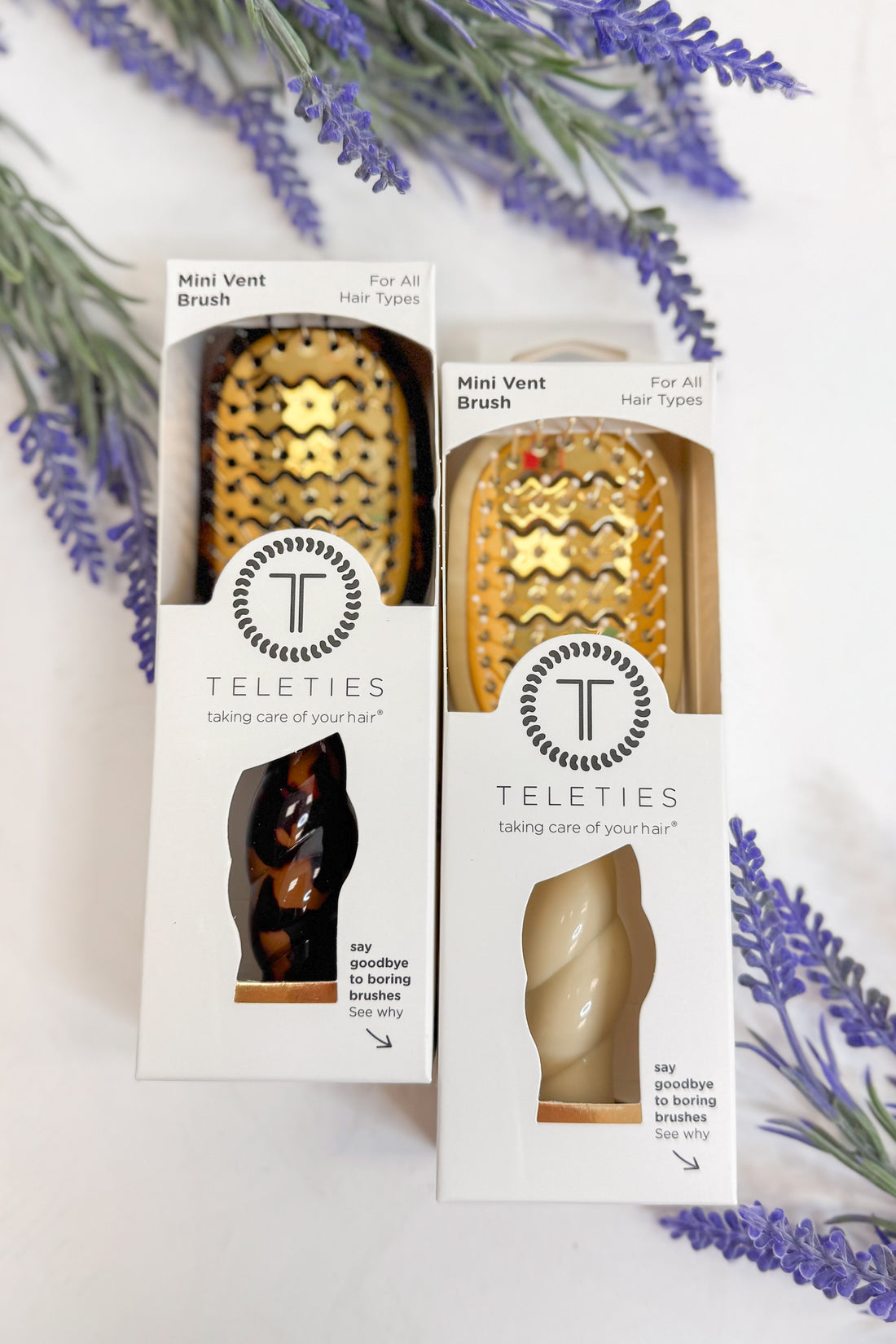 Two Teleties mini vent brushes in packaging with lavender flowers in the background
