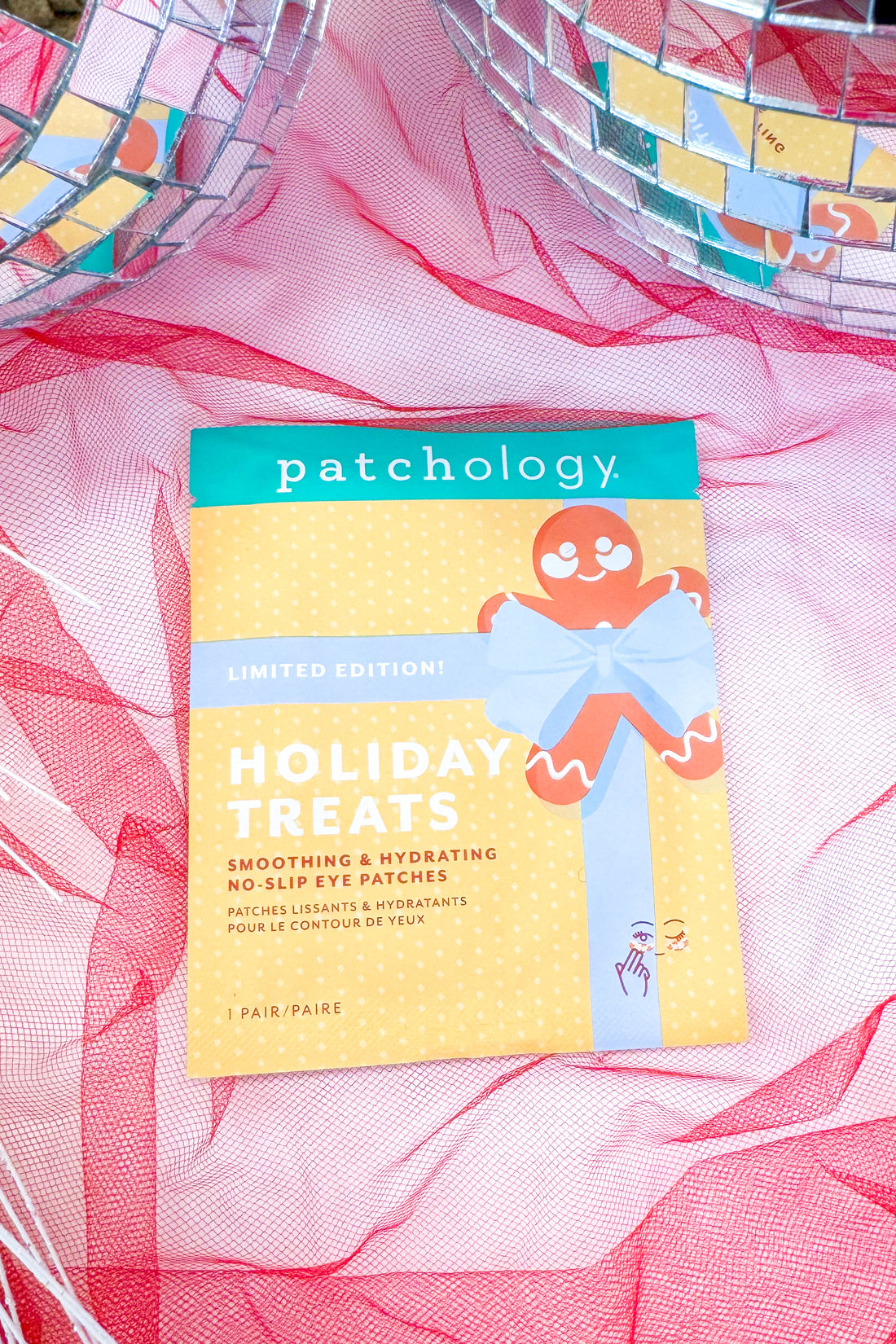 Patchology holiday treats packaging on a pink fabric background