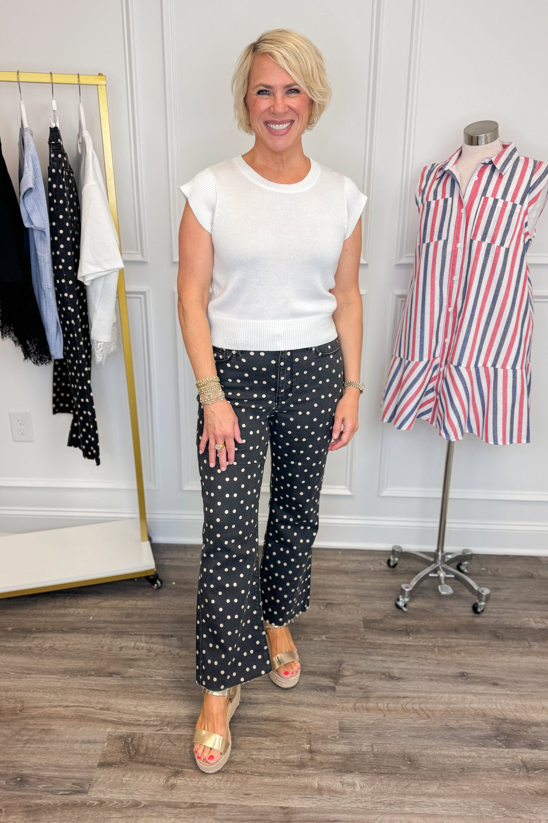 Front view of woman wearing Swagger Boutique’s Black &amp; White Polka Dot Crop Flare Jeans by Just Black Denim with top against white studio background.
