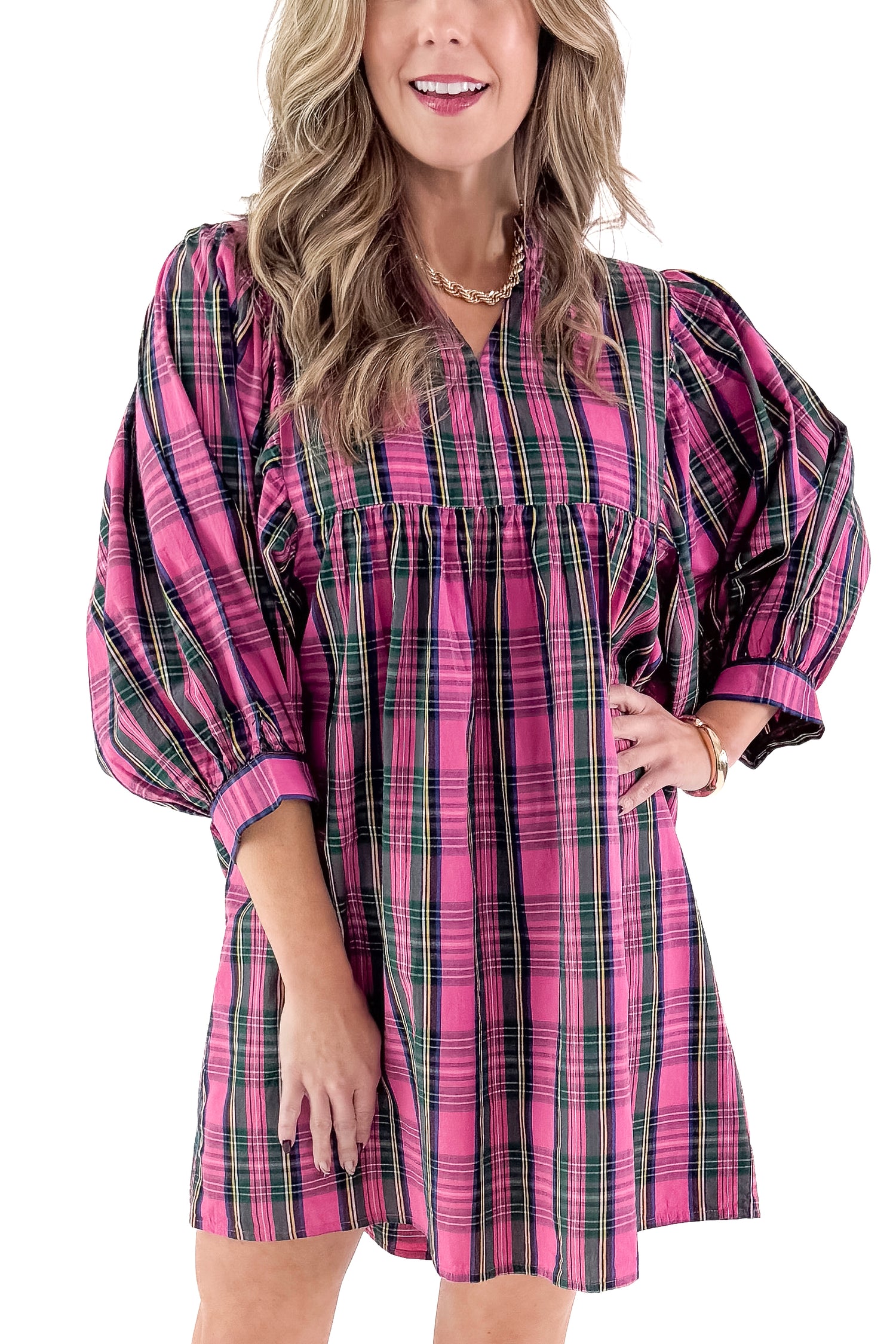 Front detailed view of woman wearing Shipley pink plaid dress against white studio background.