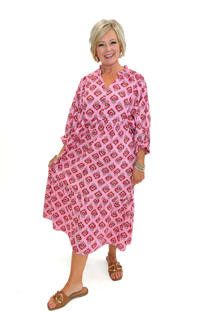 Front view of woman wearing Pink Waylon Midi Dress by MudPie against white studio background.
