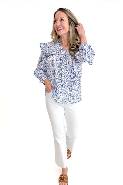Front view of woman wearing Blue Beaufort Floral 3/4 Sleeve Top by MudPie with white jeans against white studio background.