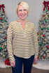 Woman wearing a striped shirt in front of Christmas trees