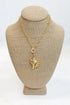 Gold necklace with a pendant on a beige mannequin bust against a white background