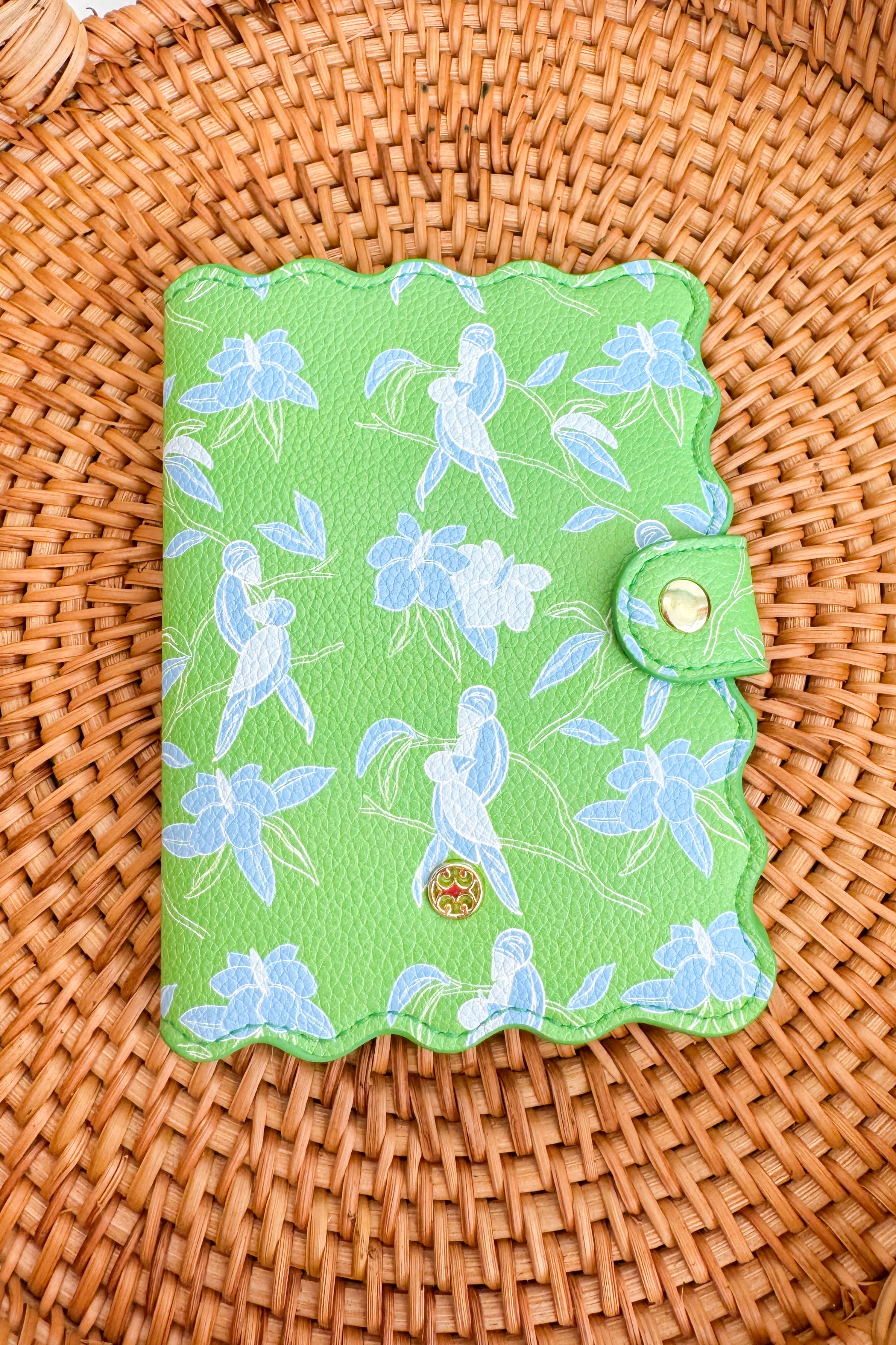 Green fabric passport cover on a woven surface