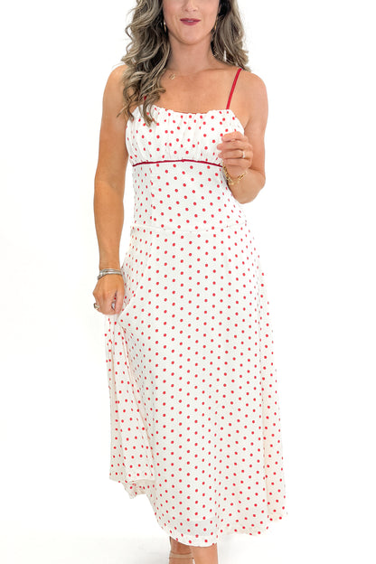 Front detail view of woman wearing Cream &amp; Red Polka Dot Midi Dress by Skies Are Blue against white studio background.