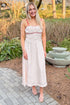 Front view of woman wearing Cream & Red Polka Dot Midi Dress by Skies Are Blue outside at a garden.
