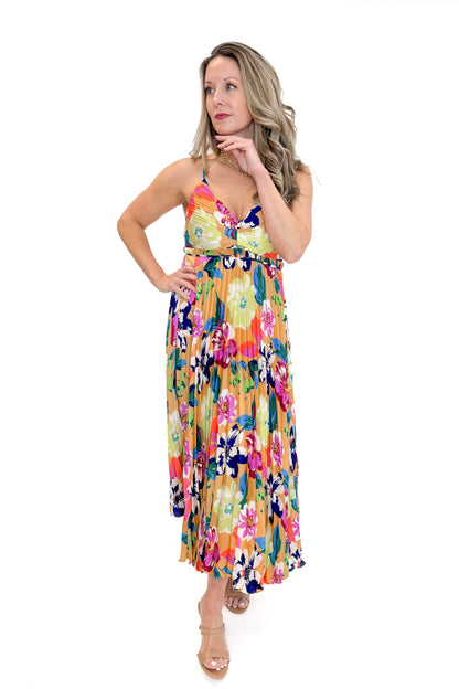 Front view of woman wearing Taupe &amp; Multi Floral Print Pleated Midi Dress by Skies Are Blue against white studio background.