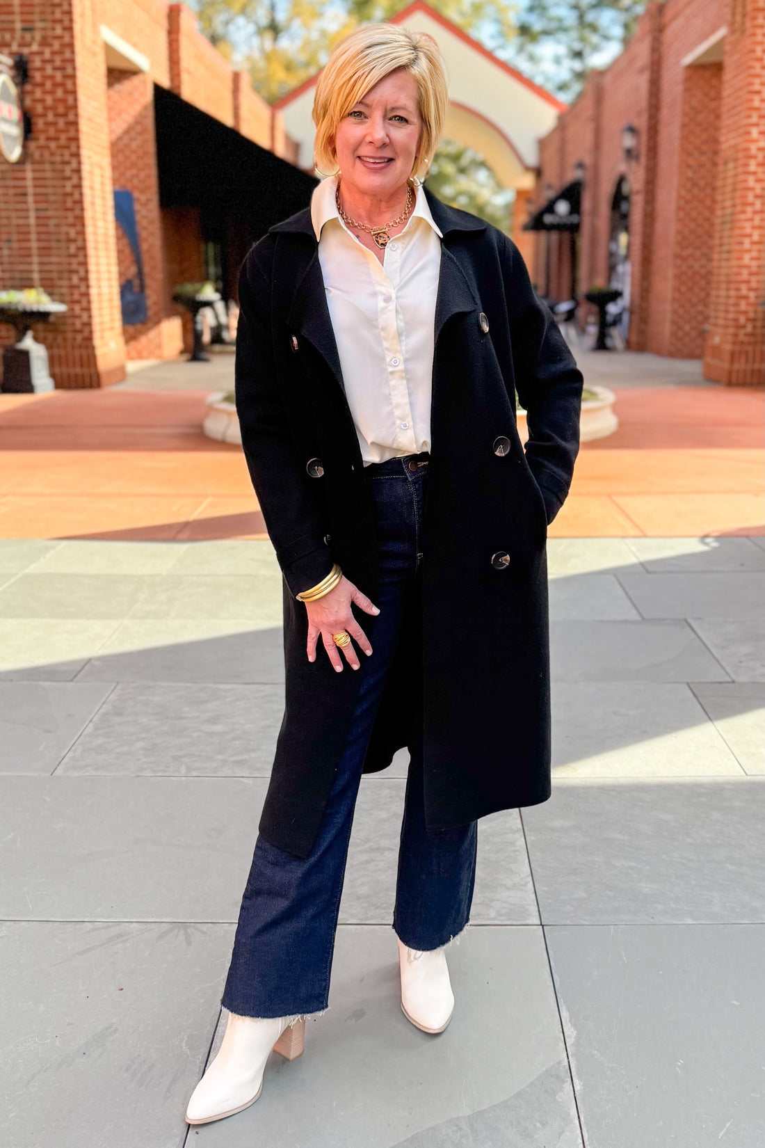 Front view of woman wearing Black Long Peacoat with jeans outside.