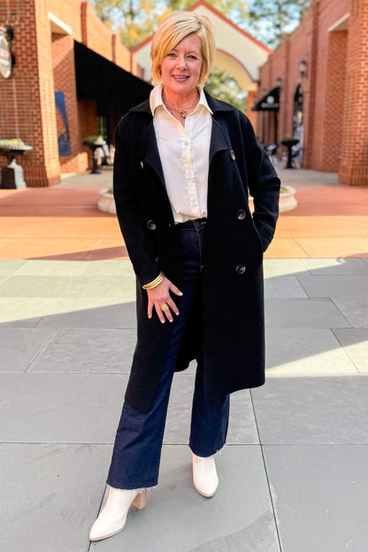Front view of woman wearing Black Long Peacoat with jeans outside.