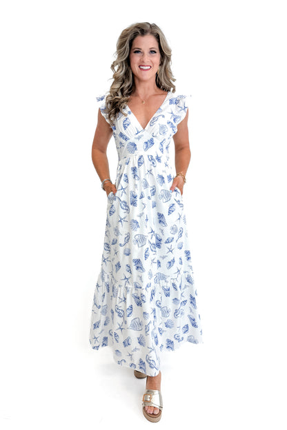 Front view of woman wearing White &amp; Blue Shell Print Tie Back Maxi Dress by Skies Are Blue against white studio background.