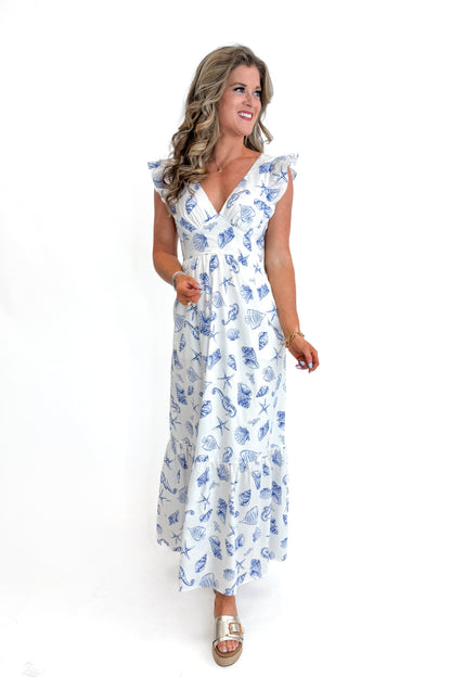 Front view of woman wearing White &amp; Blue Shell Print Tie Back Maxi Dress by Skies Are Blue against white studio background.