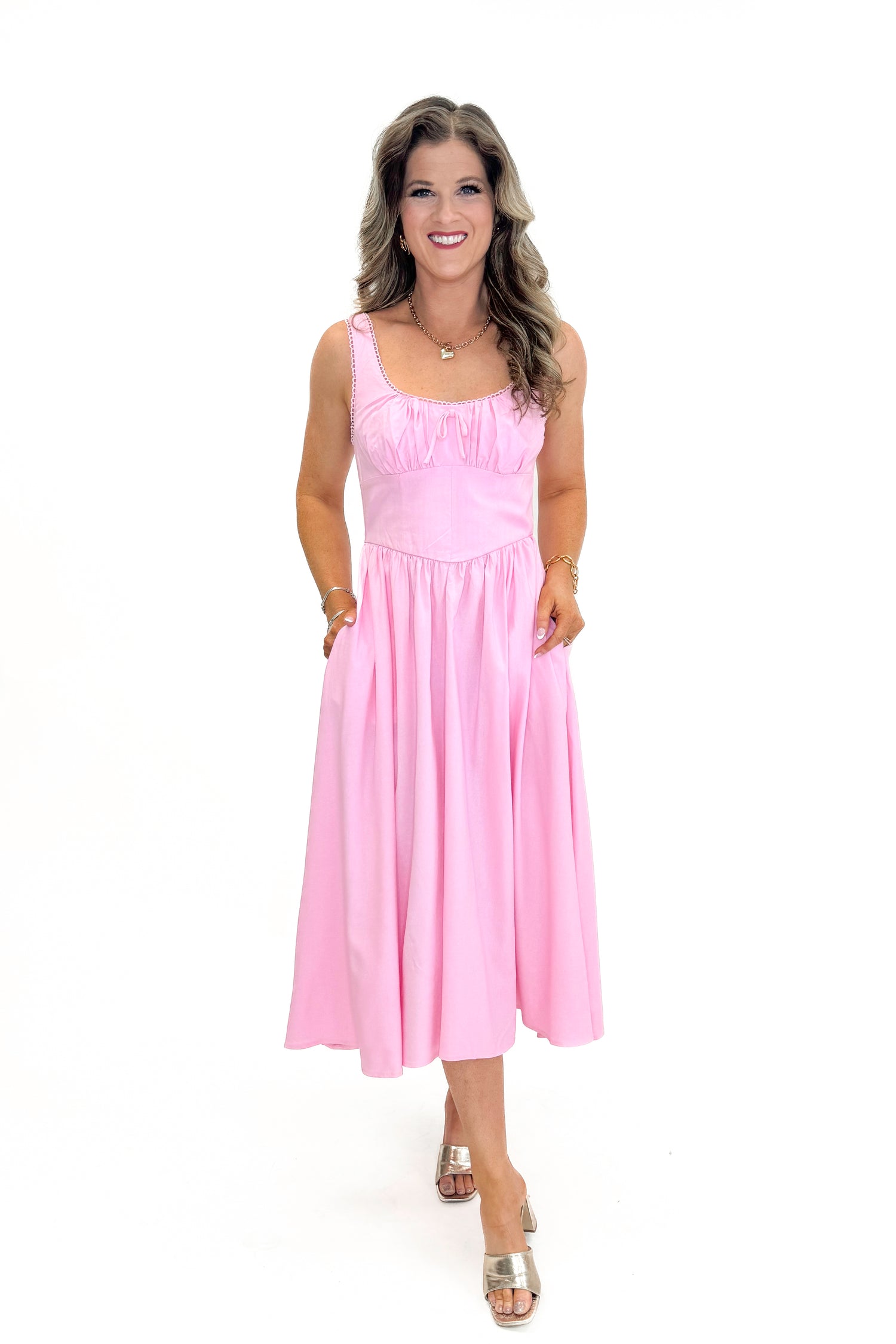 Front view of woman wearing Light Pink Drop Waist Midi Dress by Skies Are Blue  against white studio background.