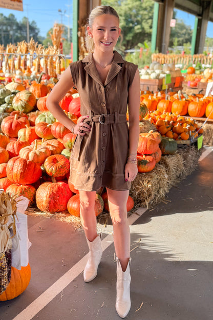 Woman wearing Turn Over A New Leaf Brown Denim Button Up Dress by Entro - front view showing button-up design and brown denim fabric