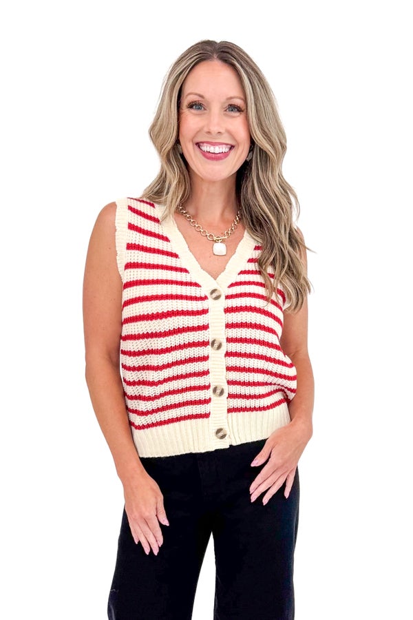 Woman wearing a red and white striped sleeveless cardigan on a white background