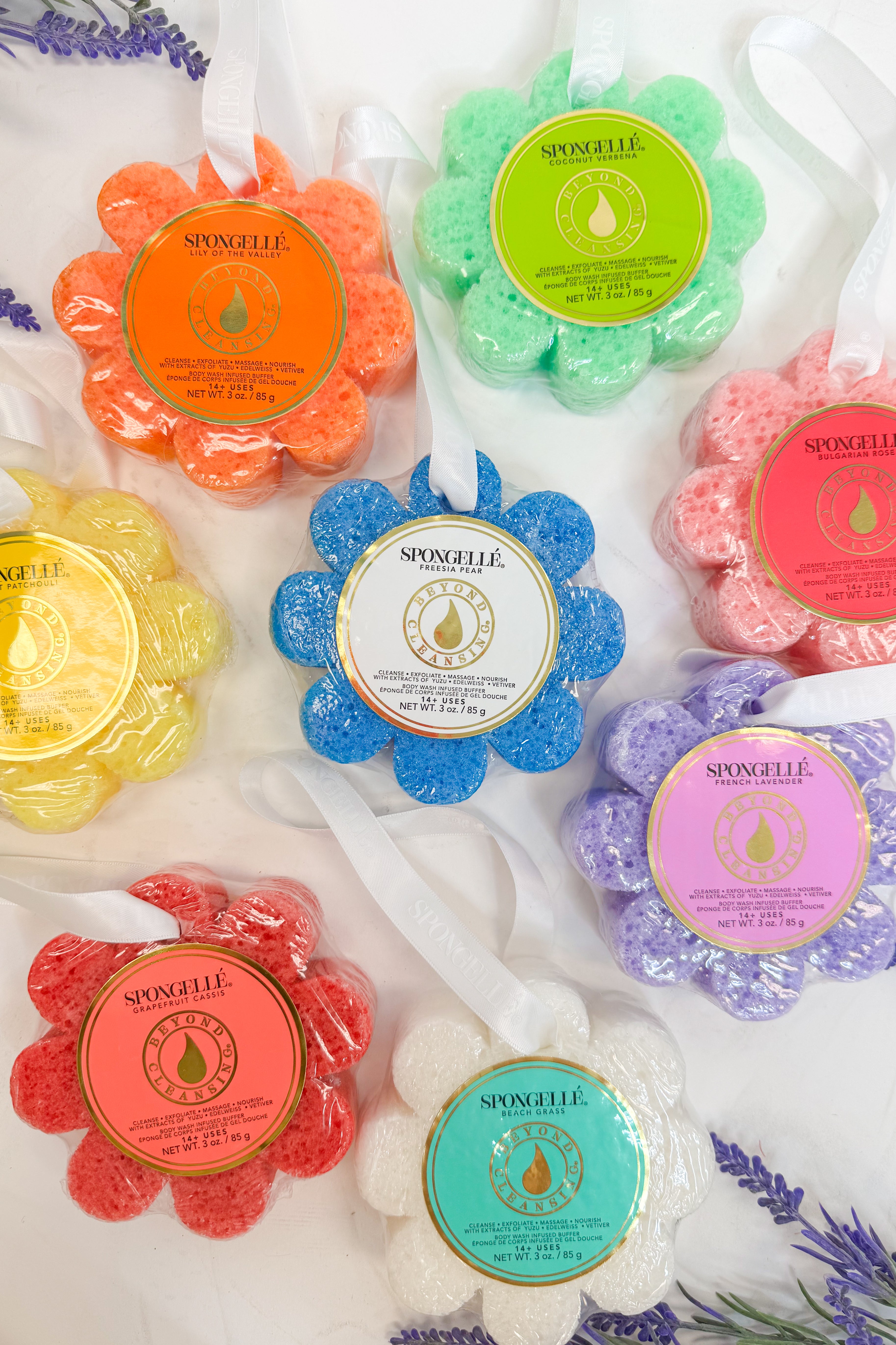 Colorful spongelle sponges with brand labels on a white background