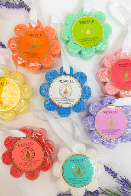 Colorful spongelle sponges with brand labels on a white background