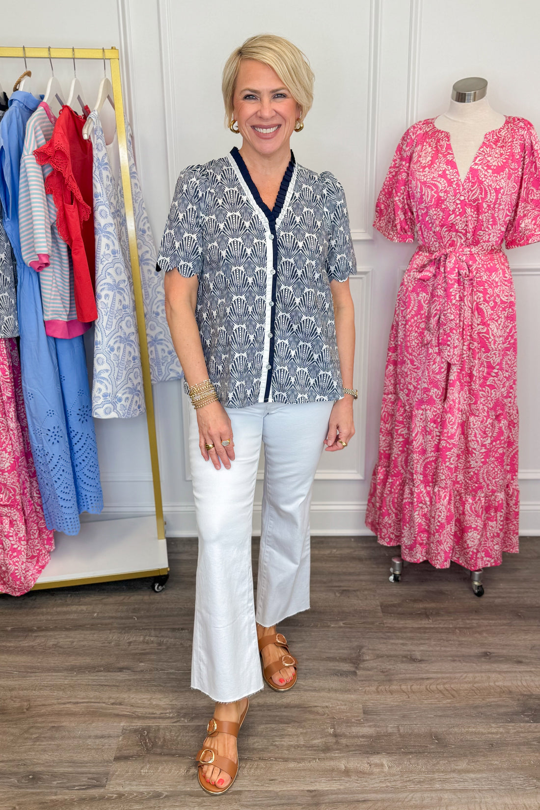 Front view of woman wearing Entro Navy Shell Top with white jeans and sandals.