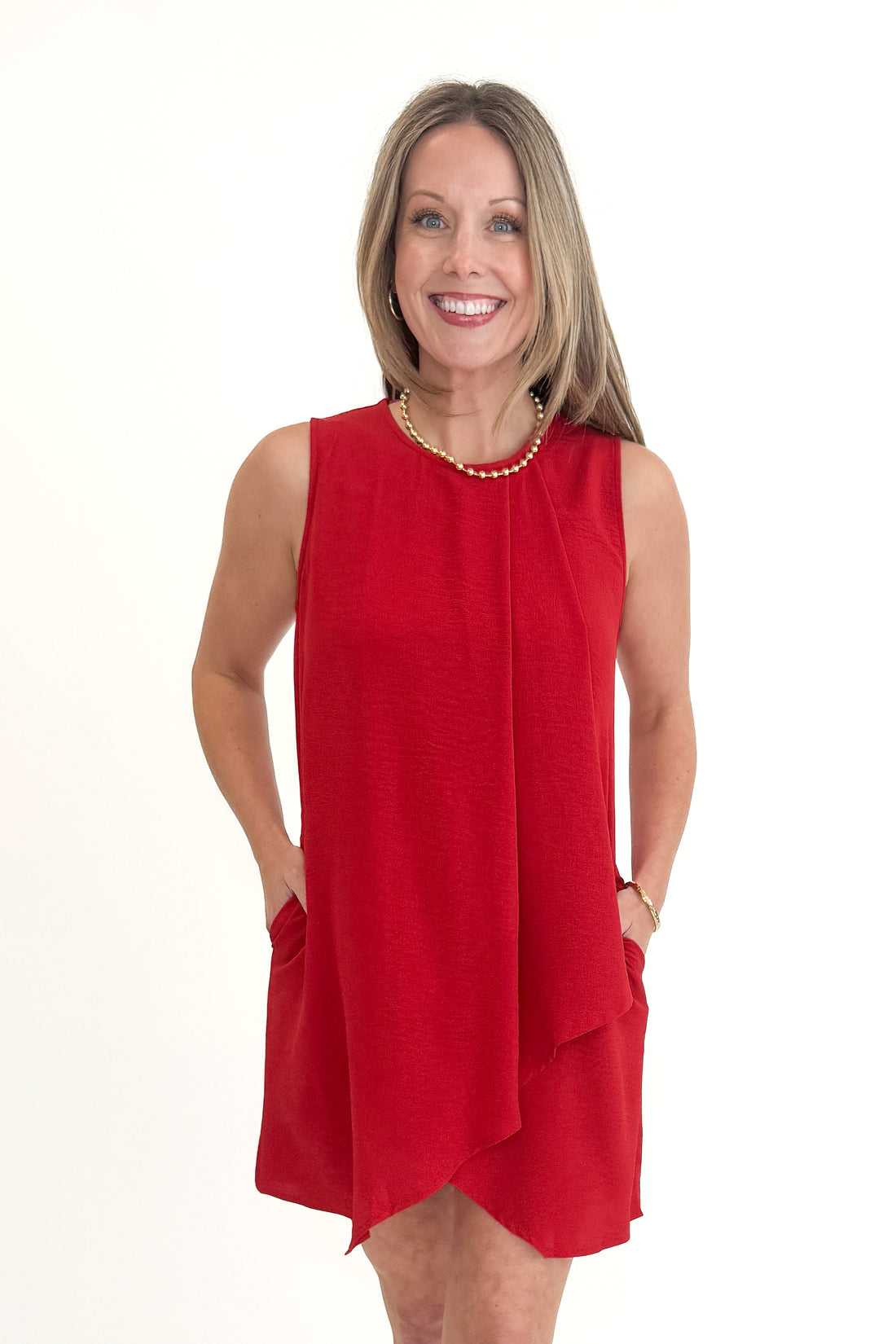 Front view of woman wearing Red Pleat Detail Shift Dress against white studio background.