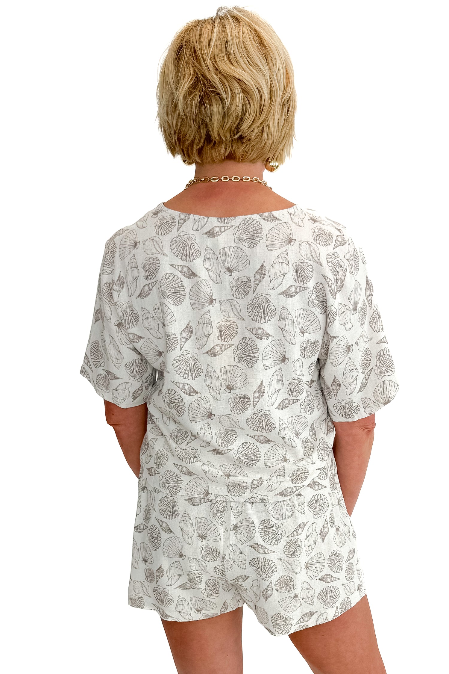 Front view of woman wearing Linen Shell Printed Top with matching shorts against white studio background.