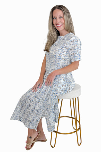 Front view of woman wearing Swagger Boutique’s Blue &amp; Brown Abstract Print Short Sleeve Top with matching skirt against white studio background.