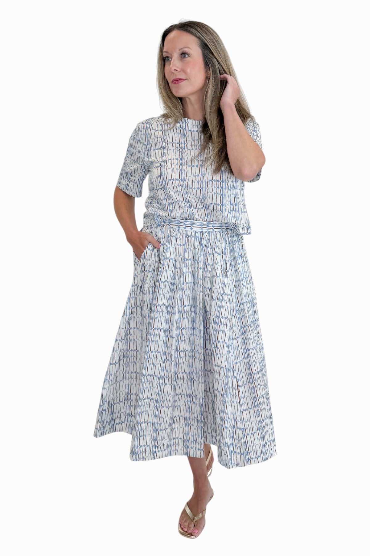 Front view of woman wearing Swagger Boutique’s Blue &amp; Brown Abstract Print Short Sleeve Top with matching skirt against white studio background.
