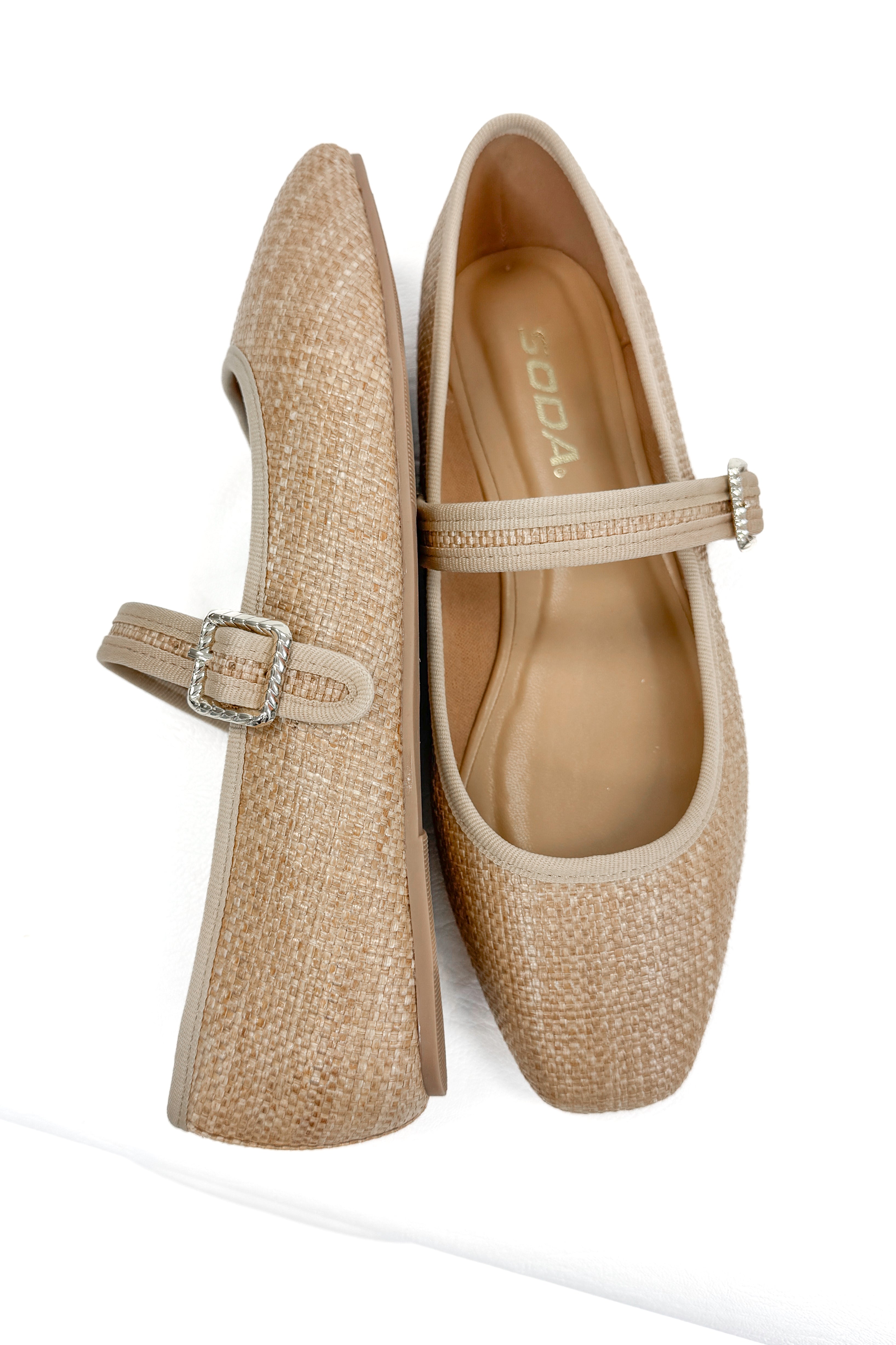 Adora- Natural Raffia Flats against white studio background.
